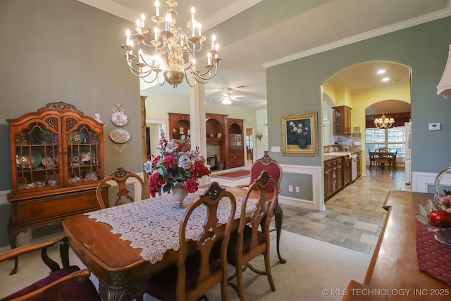 12310 S Mesa Rd, Sapulpa, OK 74066 - dining area with a chandelier, arched walkways, ornamental molding, ceiling fan, and light stone finish floors