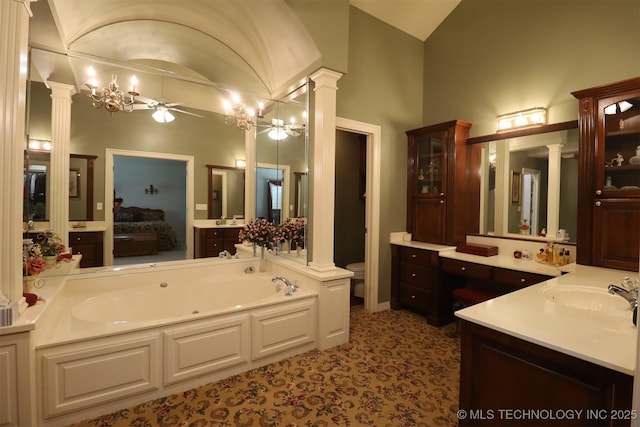12310 S Mesa Rd, Sapulpa, OK 74066 - bathroom with decorative columns, vaulted ceiling, a whirlpool tub, vanity, and ceiling fan