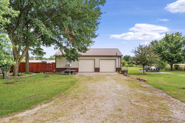 4152 W Oak St, Skiatook, OK 74070 - view of front of house featuring a garage, dirt driveway, an outbuilding, and a metal roof