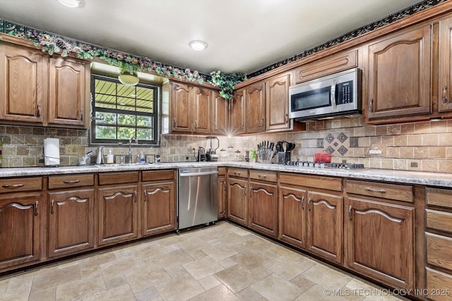 4152 W Oak St, Skiatook, OK 74070 - kitchen with stainless steel appliances, stone finish flooring, and tasteful backsplash