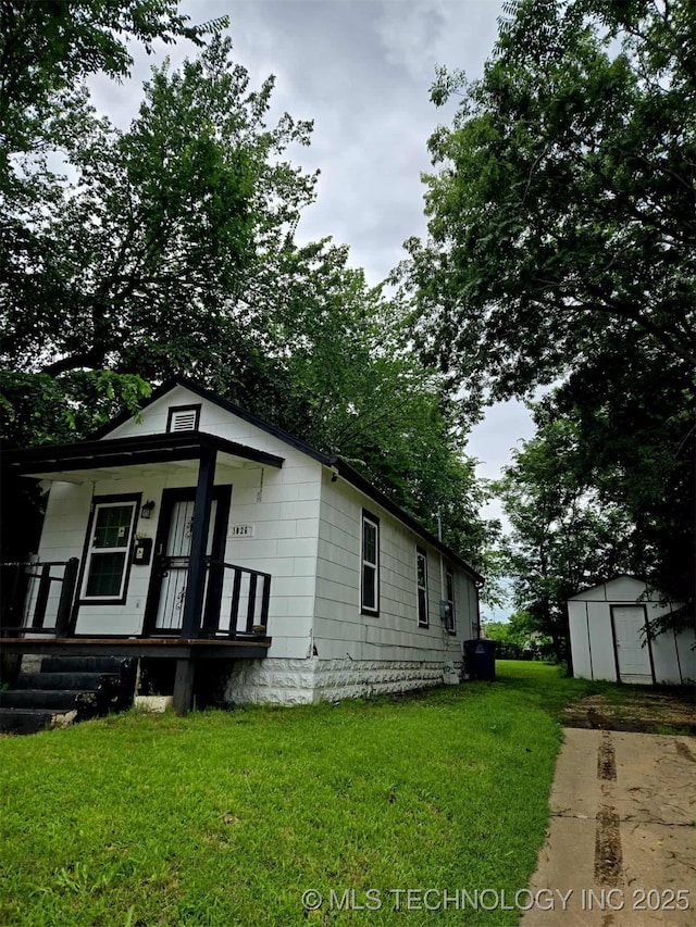 1026 N Utica Ave, Tulsa, OK 74110 - view of front of house featuring a shed, a porch, and a front lawn