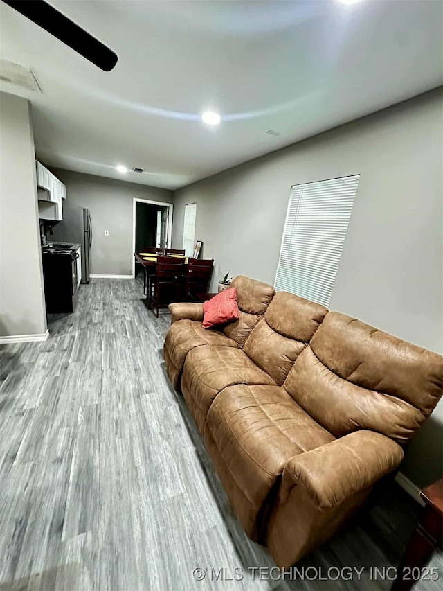 1026 N Utica Ave, Tulsa, OK 74110 - living room featuring wood finished floors and baseboards