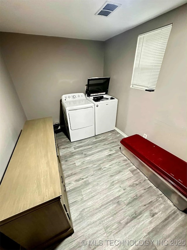 1026 N Utica Ave, Tulsa, OK 74110 - laundry room featuring washer and clothes dryer and wood finished floors