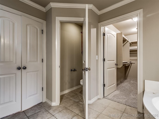 4667 E 144th Pl S, Bixby, OK 74008 - bathroom with tile patterned flooring, crown molding, a walk in closet, and vanity
