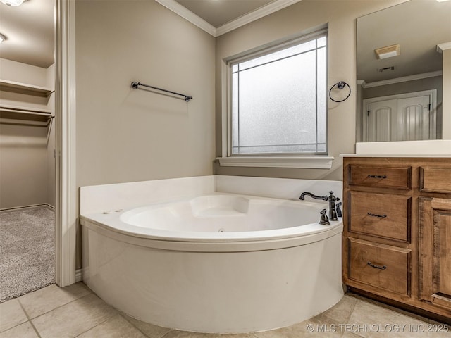 4667 E 144th Pl S, Bixby, OK 74008 - bathroom featuring ornamental molding, tile patterned floors, a jetted tub, vanity, and a walk in closet