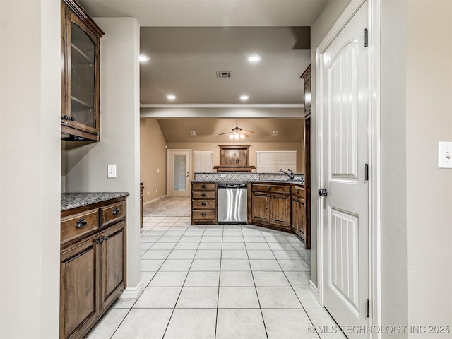 4667 E 144th Pl S, Bixby, OK 74008 - kitchen featuring stainless steel dishwasher, backsplash, light tile patterned floors, ceiling fan, and glass insert cabinets