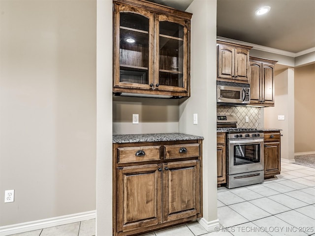 4667 E 144th Pl S, Bixby, OK 74008 - kitchen featuring appliances with stainless steel finishes, ornamental molding, glass insert cabinets, light tile patterned floors, and tasteful backsplash