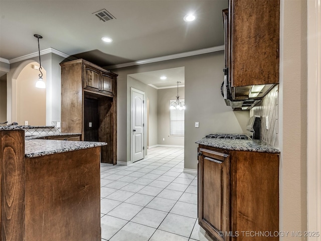 4667 E 144th Pl S, Bixby, OK 74008 - kitchen featuring ornamental molding, stone countertops, light tile patterned flooring, decorative light fixtures, and arched walkways
