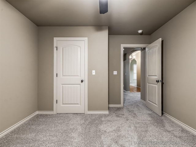 4667 E 144th Pl S, Bixby, OK 74008 - unfurnished bedroom featuring carpet, arched walkways, and a ceiling fan