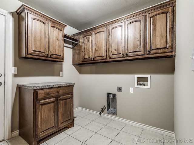 4667 E 144th Pl S, Bixby, OK 74008 - laundry area featuring cabinet space, hookup for a washing machine, gas dryer hookup, light tile patterned floors, and a textured ceiling