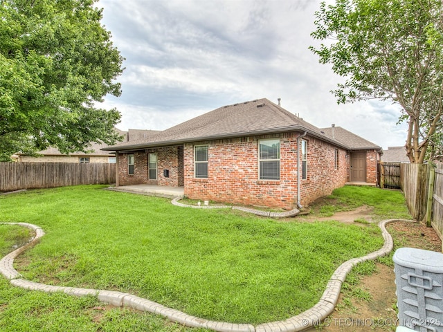 4667 E 144th Pl S, Bixby, OK 74008 - rear view of house with brick siding, a fenced backyard, a patio, and roof with shingles