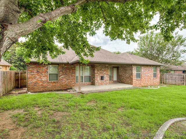 4667 E 144th Pl S, Bixby, OK 74008 - rear view of property featuring brick siding, a fenced backyard, a patio, and a shingled roof