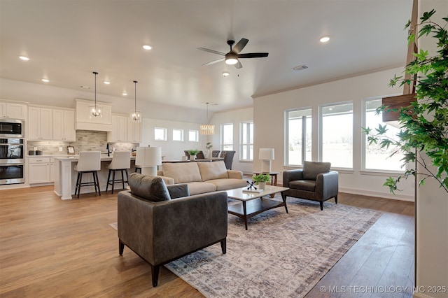 1416 N 71st St, Broken Arrow, OK 74014 - living room with ceiling fan, recessed lighting, light wood-style floors, and crown molding
