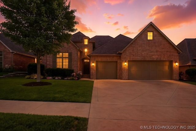2015 W 109th St, Jenks, OK 74037 - view of front of property featuring brick siding, a front lawn, a garage, and concrete driveway