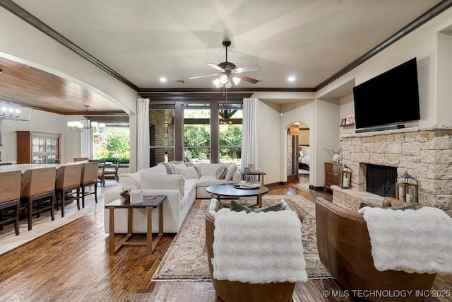2015 W 109th St, Jenks, OK 74037 - living area featuring arched walkways, crown molding, a ceiling fan, plenty of natural light, and a chandelier