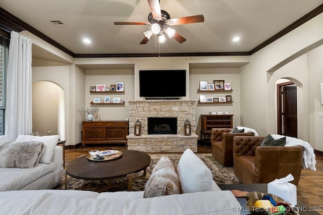 2015 W 109th St, Jenks, OK 74037 - living room with arched walkways, a ceiling fan, ornamental molding, wood finished floors, and a fireplace