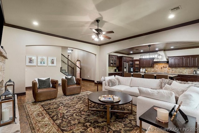 2015 W 109th St, Jenks, OK 74037 - living area featuring arched walkways, a ceiling fan, ornamental molding, stairs, and recessed lighting