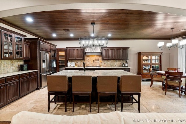 2015 W 109th St, Jenks, OK 74037 - kitchen with a chandelier, stainless steel appliances, wood ceiling, dark brown cabinetry, and tasteful backsplash