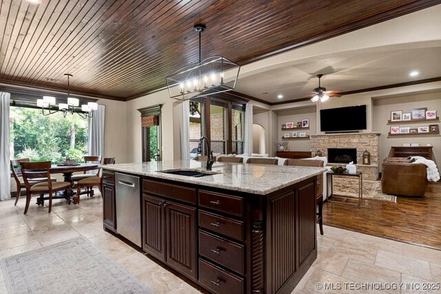 2015 W 109th St, Jenks, OK 74037 - kitchen featuring stainless steel dishwasher, ceiling fan, a chandelier, crown molding, and a fireplace