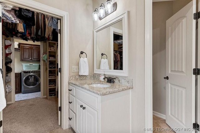 2015 W 109th St, Jenks, OK 74037 - bathroom featuring washer / clothes dryer, vanity, and a spacious closet