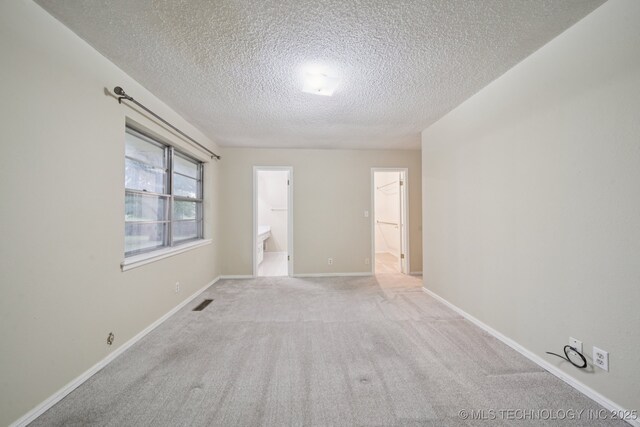 3002 E 80th Pl, Tulsa, OK 74136 - empty room with a textured ceiling and light colored carpet