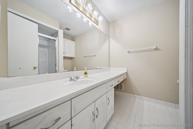 3002 E 80th Pl, Tulsa, OK 74136 - full bathroom with vanity, a stall shower, a textured ceiling, and tile patterned floors