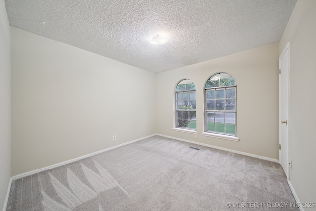 3002 E 80th Pl, Tulsa, OK 74136 - carpeted empty room with a textured ceiling and baseboards