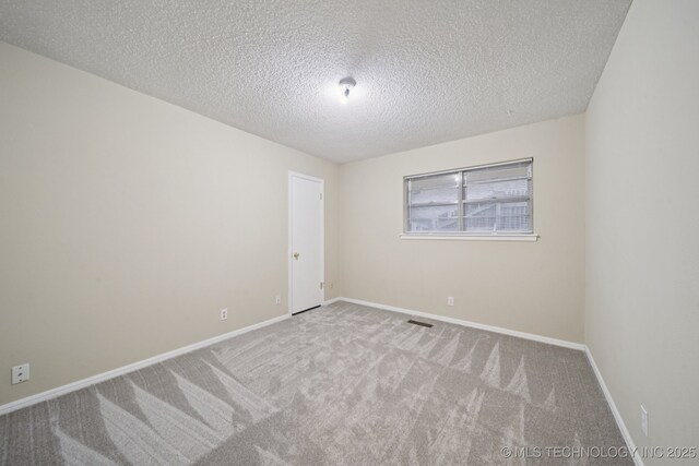 3002 E 80th Pl, Tulsa, OK 74136 - carpeted empty room with a textured ceiling and baseboards