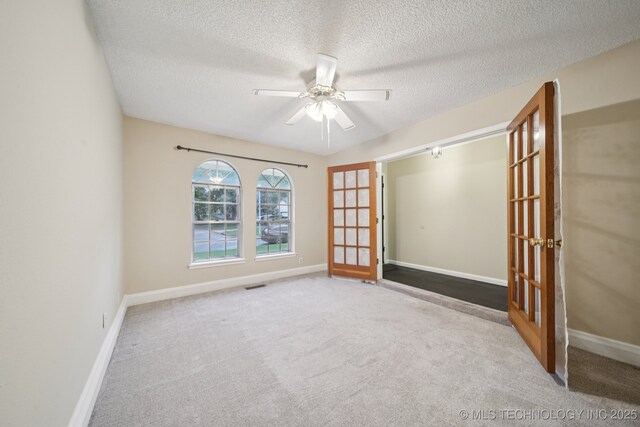 3002 E 80th Pl, Tulsa, OK 74136 - unfurnished room with carpet floors, ceiling fan, a textured ceiling, and french doors