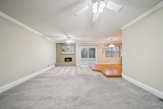 3002 E 80th Pl, Tulsa, OK 74136 - unfurnished living room featuring ceiling fan, carpet floors, ornamental molding, a large fireplace, and a textured ceiling