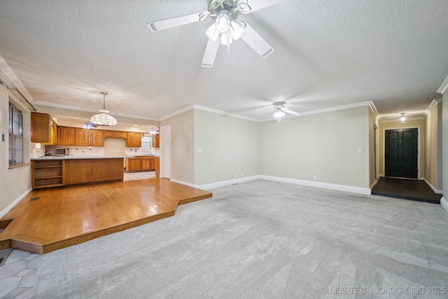 3002 E 80th Pl, Tulsa, OK 74136 - unfurnished living room featuring ceiling fan, a textured ceiling, ornamental molding, and light carpet