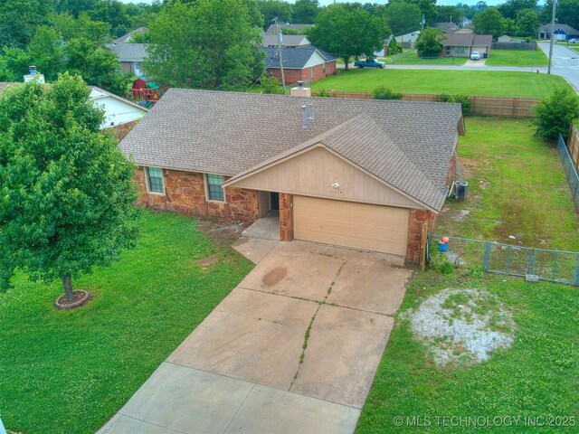 314 N Tallchief St, Skiatook, OK 74070 - view of front of house with stone siding, a shingled roof, an attached garage, and driveway