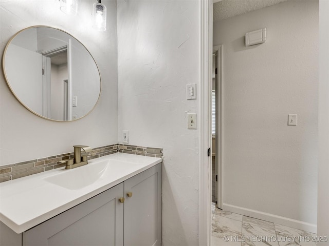 314 N Tallchief St, Skiatook, OK 74070 - bathroom with marble finish floors, vanity, and decorative backsplash