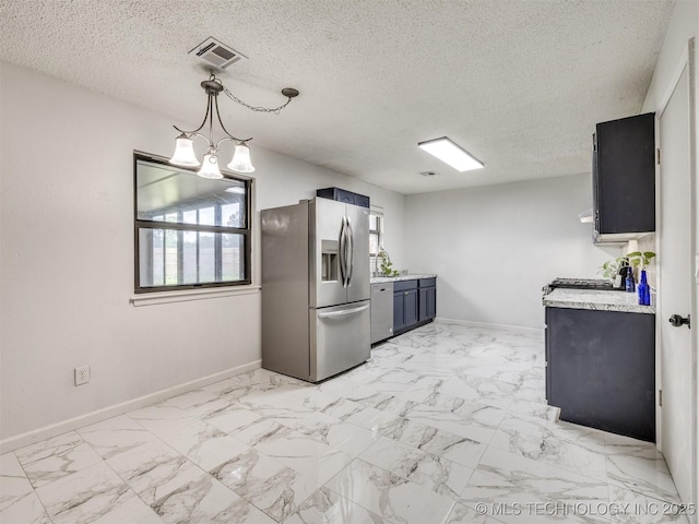 314 N Tallchief St, Skiatook, OK 74070 - kitchen with appliances with stainless steel finishes, light countertops, a chandelier, a textured ceiling, and light marble finish floors