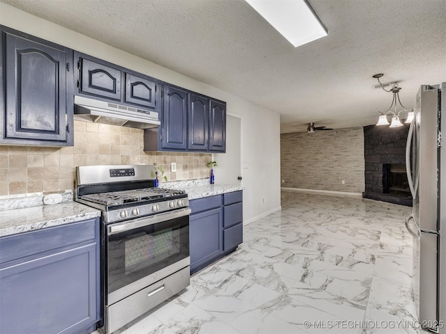 314 N Tallchief St, Skiatook, OK 74070 - kitchen featuring appliances with stainless steel finishes, under cabinet range hood, a large fireplace, light marble finish floors, and blue cabinetry