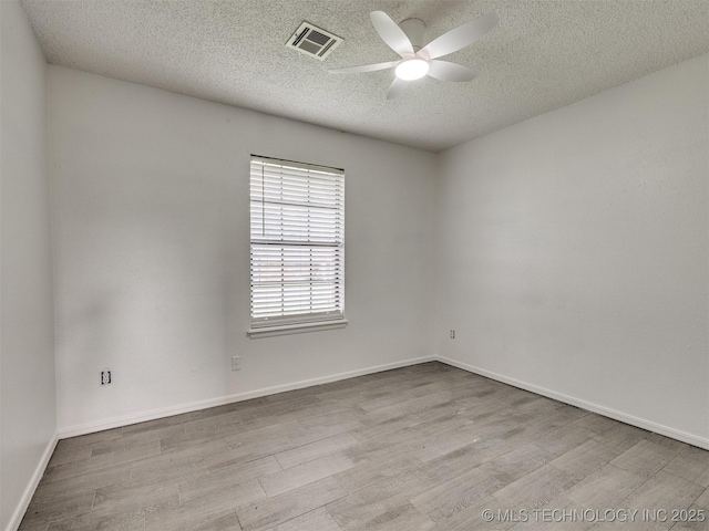 314 N Tallchief St, Skiatook, OK 74070 - unfurnished room featuring a ceiling fan, wood finished floors, and a textured ceiling