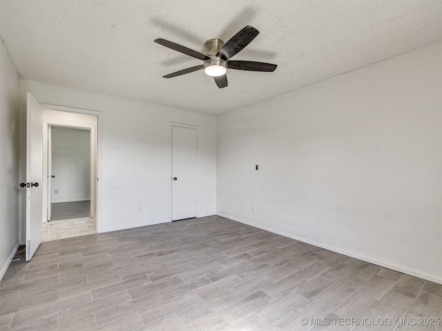 314 N Tallchief St, Skiatook, OK 74070 - unfurnished bedroom featuring light wood finished floors, a textured ceiling, ceiling fan, and a closet