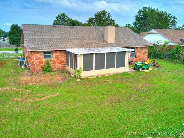 314 N Tallchief St, Skiatook, OK 74070 - rear view of house with stone siding, a chimney, a sunroom, and a shingled roof