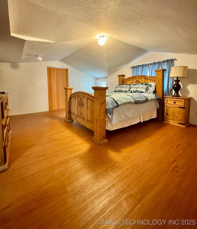 115842 S 4196, Checotah, OK 74426 - bedroom featuring wood finished floors, a textured ceiling, and lofted ceiling
