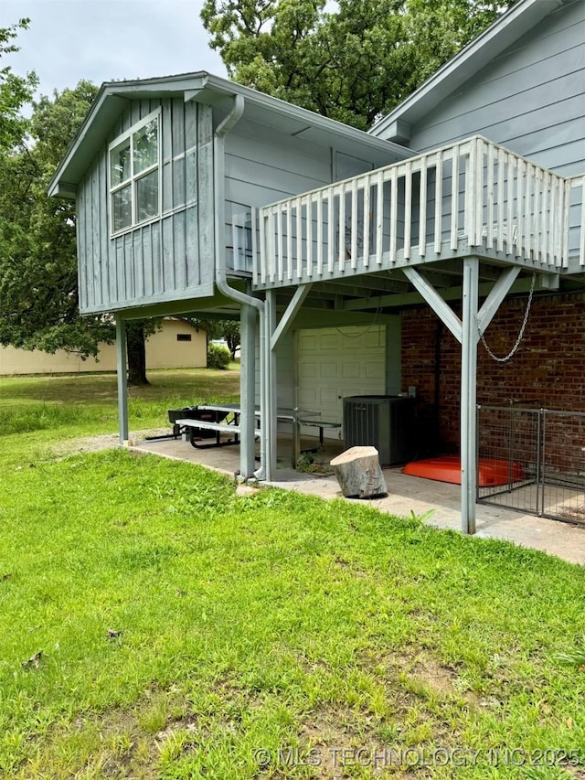 115842 S 4196, Checotah, OK 74426 - view of side of home featuring an attached garage, a lawn, and board and batten siding