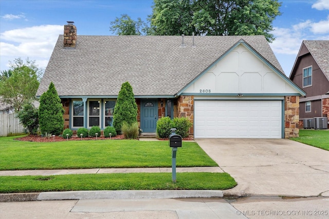 2605 W Atlanta Ct, Broken Arrow, OK 74012 - tudor home featuring a chimney, a shingled roof, stone siding, and a front yard