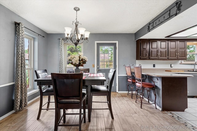 2605 W Atlanta Ct, Broken Arrow, OK 74012 - dining area featuring a chandelier and light wood-style floors