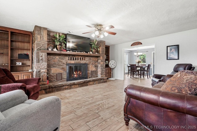 2605 W Atlanta Ct, Broken Arrow, OK 74012 - living room featuring a ceiling fan, a fireplace, a textured ceiling, wood finished floors, and built in shelves