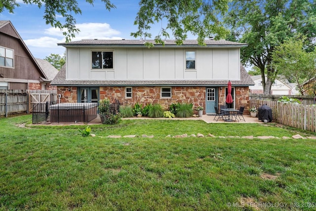 2605 W Atlanta Ct, Broken Arrow, OK 74012 - back of house with board and batten siding, a patio, stone siding, and a fenced backyard