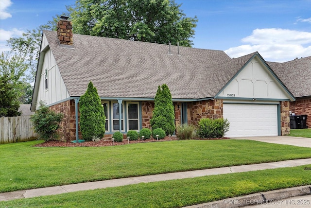 2605 W Atlanta Ct, Broken Arrow, OK 74012 - tudor house with stone siding, a shingled roof, a garage, a chimney, and driveway