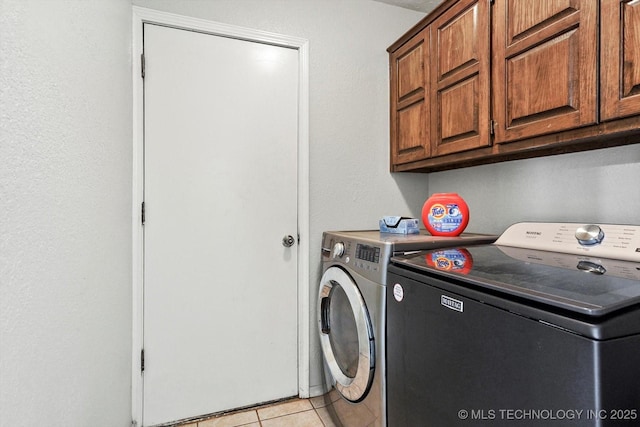2605 W Atlanta Ct, Broken Arrow, OK 74012 - laundry room featuring independent washer and dryer, cabinet space, and light tile patterned flooring