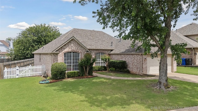 1101 S Yellowood Ave, Broken Arrow, OK 74012 - french country style house with brick siding, a shingled roof, concrete driveway, and an attached garage