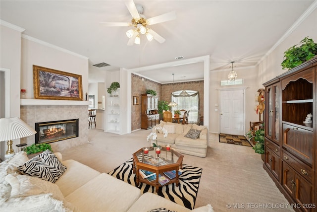 1101 S Yellowood Ave, Broken Arrow, OK 74012 - living area with light carpet, a tile fireplace, a ceiling fan, and crown molding