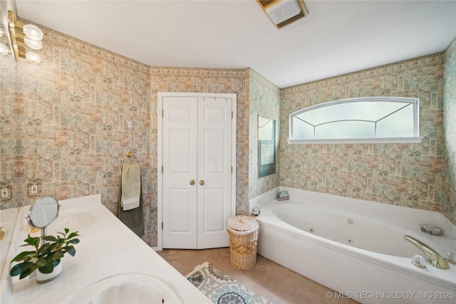 1101 S Yellowood Ave, Broken Arrow, OK 74012 - full bath featuring a jetted tub, double vanity, wallpapered walls, and a closet