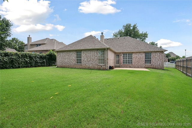 1101 S Yellowood Ave, Broken Arrow, OK 74012 - back of house with a fenced backyard, a patio, brick siding, a chimney, and a shingled roof